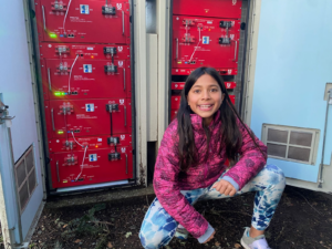 Sophie Leitner at a PowerBloc in an outdoor cabinet after replacing a communications cable.