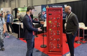 YouSolar’s Marcus Saye explains the PowerBloc to a visitor at YouSolar’s booth at the International Builders’ Show in Las Vegas.