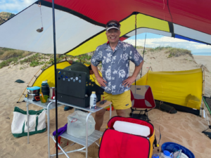 Arnold Leitner, CEO of YouSolar, cooking lunch on Polihale Beach, Kauai.