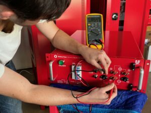 Marcus Saye, Mechanical Engineer, tests the new 100 V battery.